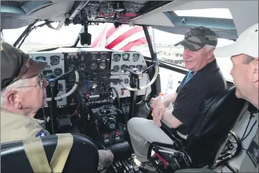  ?? NATALIE KOLB ?? From left, WWII Weekend special guest Carl Constein, Gov. Tom Corbett, and Alexander Mello talk inside of “Tinker Belle,” a Curtiss C-46, during World War II Weekend at the Mid-Atlantic Air Museum in Bern Township on Saturday afternoon June 7, 2014. Photo by Natalie Kolb 6/7/2014