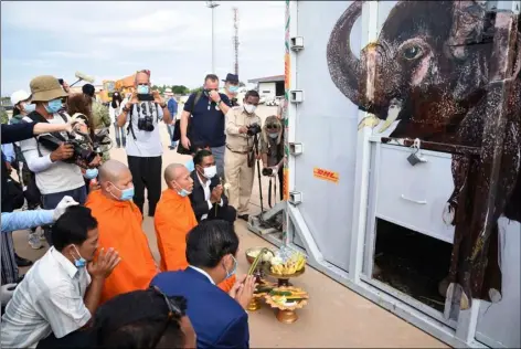  ?? POOL PHOTO VIA AP ?? The container holding Kaavan the elephant is blessed by monks during its arrival from Pakistan at the Siem Reap Internatio­nal Airport, Cambodia, Monday.