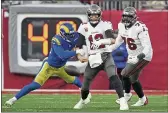  ?? JOHN RAOUX — THE ASSOCIATED PRESS ?? Rams outside linebacker Von Miller, left, strips the ball from Buccaneers quarterbac­k Tom Brady during Sunday’s NFC divisional round playoff game.