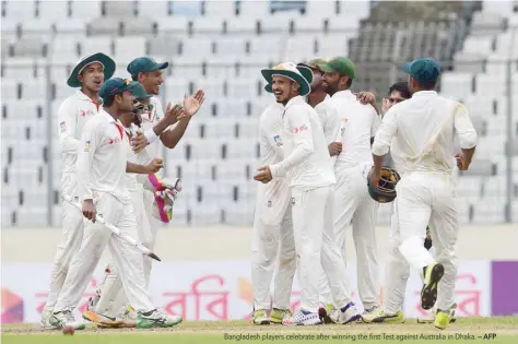  ?? — AFP ?? Bangladesh players celebrate after winning the first Test against Australia in Dhaka.