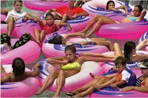  ??  ?? (ABOVE Left ) Pink, 1999 Sunbathers relax in a jam of pink inner tubes at the Hawaiian Waters Adventure Park in Kapolei, Hawaii. Picture taken with Nikon D1