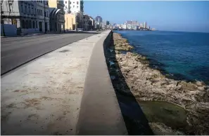  ?? Associated Press ?? The malecon is completely empty of tourists Tuesday in Havana, Cuba.