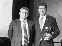  ??  ?? Curt Bernardi, right, of Silver Wheaton Corp.,
accepts the Deal Making award.