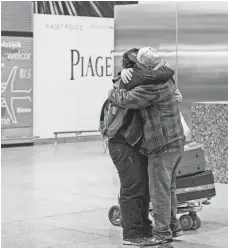  ?? ALEXANDER F. YUAN, AP ?? Abdullah Alghazali, right, hugs his son Ali in February after the Yemeni boy arrived at Kennedy Airport in New York City.