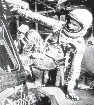  ?? Associated Press ?? THE FIRST AMERICAN TO ORBIT EARTH Astronaut John Glenn climbs into the capsule of Friendship 7 at Cape Canaveral, Fla., in 1962.