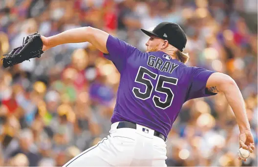  ?? Photos by Joe Amon, The Denver Post ?? Rockies pitcher Jon Gray delivers against the Cincinnati Reds during a 3-2 victory on July 12 at Coors Field, a place that doesn’t intimidate him. “I know it’s hard to pitch here, and I take a lot of pride in that. You know that other guy has to deal with it, too,” he says.