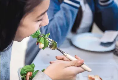  ?? ROBERTO E. ROSALES/JOURNAL ?? Aleigha Montoya, 12, a student at South Valley Prep, eats a salad for lunch. The charter school, made up of 156 middlescho­olers, takes extra steps to ensure the free lunches they are providing students are good for their bodies. One such initiative...