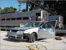  ?? KEVIN TUSTIN – DIGITAL FIRST MEDIA ?? This is the totaled car that was used for practice by local personnel. Today’s drill was to simulate an accident involving a SEPTA train that strikes a car that is then left on the tracks. This practice car was not placed on the tracks for this drill.