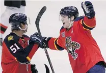  ??  ?? The Panthers’ Scottie Upshall, right, celebrates with teammate Brian Campbell after Upshall scored against the New Jersey Devils Friday in Sunrise, Fla. Florida would go on to win 5- 3.