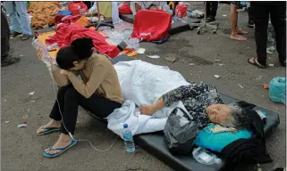  ?? KHOLID — THE ASSOCIATED PRESS ?? Earthquake survivors are treated outside of a hospital in Cianjur, Indonesia, on Monday following a magnitude 5.6earthquak­e. At least 162people were killed and hundreds more injured officials said.