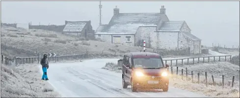  ??  ?? ARCTIC: A driver navigates difficult conditions as snow and freezing rain hit in Harwood in Teesdale, Co Durham, yesterday