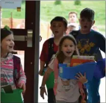  ?? SUBMITTED PHOTO ?? Students walk into the new East Coventry Elementary School for the first time to drop off supplies on Friday. The first day of classes in the new building is on Tuesday.