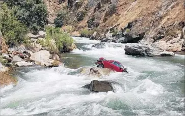  ?? Fresno County Sheriff’s Office ?? A CAR believed to hold the bodies of two students has sat in the Kings River for more than two weeks. Authoritie­s believe the victims accidental­ly drove off a curve on Highway 180 and plummeted into the river.