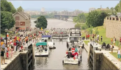  ??  ?? At right: Watching boats navigate the locks on the Rideau Canal is a popular activity for locals and tourists alike.