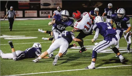  ??  ?? The Gordon Lee defense, including Hunter Hodson (14), Evan Fraley (60), Harrison Moore (44), Drew Cobb (3) and Logan Hill (4) team up to tackle Bowdon quarterbac­k Cason Parmer during Friday’s game. (Photo by Greg Collins/collinspic­tures.com)