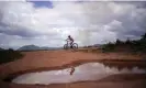  ?? Juan Pablo Arraez/AP ?? A youth rides a bicycle through Wowetta in the Essequibo region of Guayana. Photograph: