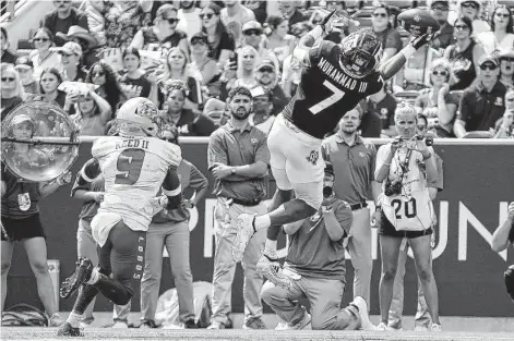  ?? Photos by Sam Craft / Associated Press ?? Texas A&M receiver Moose Muhammad III makes a one-handed catch for a touchdown in front of New Mexico safety Jerrick Reed II.