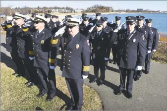  ?? Arnold Gold / Hearst Connecticu­t Media ?? Members of the West Haven Fire Department Honor Guard salute as the names of Connecticu­t servicemen who died during the Japanese attack on Pearl Harbor are read Friday. Above left, they raise the flag during the commemorat­ion of the 77th anniversar­y of Pearl Harbor, held at Bradley Point Park in West Haven Friday.