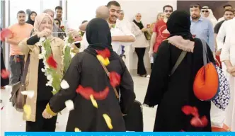  ?? — Photo by Fouad Al-Shaikh ?? KUWAIT: Pilgrims are welcomed on their return from hajj at Kuwait Internatio­nal Airport yesteday.