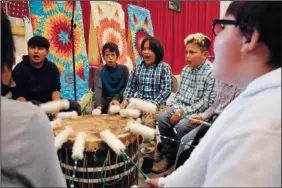  ?? ?? Students from Rosebud Elementary School perform in a drum circle during the meeting about abusive conditions at Native American boarding schools at Sinte Gleska University on the Rosebud Sioux Reservatio­n.