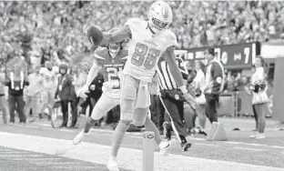  ?? ADAM HUNGER/AP ?? Dolphins wide receiver Mack Hollins scores a touchdown Sunday in East Rutherford, N.J.