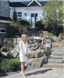  ?? CHRISTINA RYAN/ CALGARY HERALD ?? Realtor Corinne Poffenroth calls a Calgary home that’s listing for $ 12.25 million “a very unique property.”