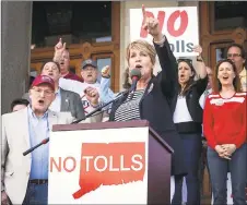  ?? Melanie Stengel / Associated Press ?? State Rep. Laura Devlin of Fairfield addresses a crowd of antitoll protesters in front of the Capitol in Hartford in May.