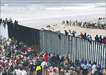  ?? Alejandro Tamayo San Diego Union-Tribune ?? MIGRANTS and supporters at the U.S.-Mexico border in Playas de Tijuana in April 2018. The Trump administra­tion sought sweeping changes to the asylum system in response to the f lood of Central American arrivals.