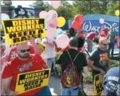  ?? STEPHEN M. DOWELL — ORLANDO SENTINEL VIA AP, FILE ?? Unionized workers for Walt Disney World and their supporters march and chant in front of Disney hotel property in Orlando, Fla.