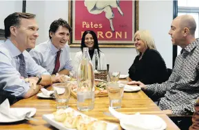  ?? NATHAN DENETTE / THE CANADIAN PRESS ?? Bill Morneau, Justin Trudeau and Bardish Chagger sit down for lunch with the owners of Pastaggio Italian Eatery, in Stouffvill­e, Ont., on Monday.