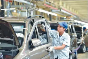  ?? ZHU XUDONG / XINHUA ?? A Changan technician tests a car at a production line located in Dingzhou, Hebei Province.