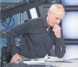  ??  ?? Hockey Night in Canada host Ron McLean looks over some pregame notes figuring out what they will talk about and what clips to be shown.