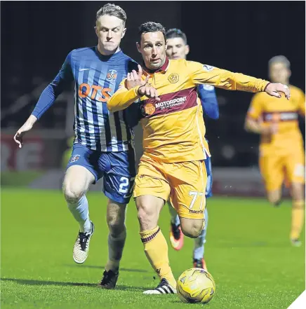  ??  ?? ■ Kilmarnock’s Luke Hendrie tussles with veteran Motherwell striker Scott McDonald.