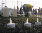  ??  ?? More than 100 gathered at Waterfront Park Saturday evening for a vigil to mourn the victims in Georgia.