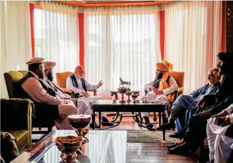  ?? AP ?? Former Afghan President Hamid Karzai, center left, and senior Haqqani group leader Anas Haqqani, center right, meet in Kabul on Wednesday.