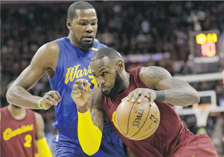  ?? — THE ASSOCIATED PRESS FILES ?? Cleveland’s LeBron James drives past Golden State’s Kevin Durant during regular-season action. The two will see a lot of one another in the NBA Finals.