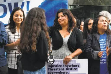  ?? Sarahbeth Maney / Special to The Chronicle ?? Cristina Morales (center) talks at a news conference with her daughter, Crista Ramos, 14, plaintiff in a suit seeking to block President Trump’s curtailmen­t of Temporary Protected Status for some nationals.