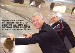  ??  ?? Reporter Steve MacNaull lent a hand to push the L-10A aircraft into place at the launch event in Air Canada’s hangar at Vancouver Internatio­nal Airport.