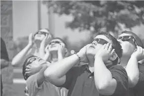  ?? ZACH TUGGLE/TELEGRAPH-FORUM ?? Sam Gregg and several of his fifth-grade classmates at Galion Intermedia­te School used special glasses to look at the solar eclipse in August of 2017.