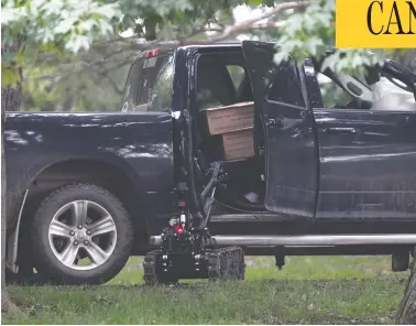  ?? ADRIAN WYLD / THE CANADIAN PRESS ?? A police robot helps search a truck on the grounds of Rideau Hall in Ottawa on Thursday, after an armed gunman crashed the gates. Among the weapons seized were a Norinco M14 rifle and high-capacity magazine, both prohibited.