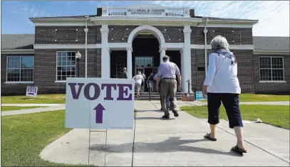  ?? Butch Dill ?? The Associated Press Voters arrive to cast their ballots during the Alabama primary election Tuesday at Huntingdon College in Montgomery, Ala.