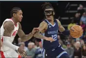  ?? BRANDON DILL — THE ASSOCIATED PRESS ?? Grizzlies guard Ja Morant handles the ball against Houston Rockets guard Kevin Porter Jr. in the second half Wednesday.