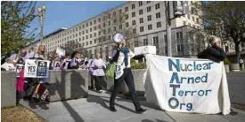  ?? —AFP ?? NONBELIEVE­RS Demonstrat­ors march past the state department in Washington as they protest against the North Atlantic Treaty Organizati­on on April 4.