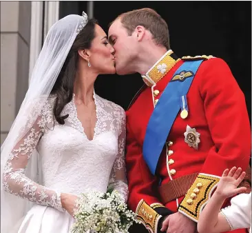  ??  ?? Prince William and his new wife Kate Middleton kissing on the balcony of Buckingham Palace following their wedding