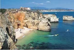  ??  ?? Lagos on Portugal’s Algarve where the rising pound has cut bills for Britons