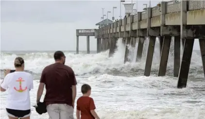  ?? NICK TOMECEK/AP ?? Waves crash against the Okaloosa Fishing Pier on Okaloosa Island in Fort Walton Beach as Hurricane Michael approaches the Panhandle.