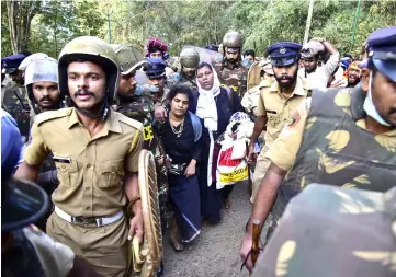  ??  ?? File photo shows Indian police escorting Durga (centre left) and Bindu (centre right) after their group of women were stopped by hardline activists during an effort to reach the Sabarimala Ayyapa temple from Pamba in the southern state of Kerala.— AFP photo