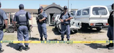  ?? PICTURE: TRACEY ADAMS ?? Police swooped on a home in Lydia Street, Valhalla Park, and found a quantity of firearms kept in three undergound safes. The angry community outside hurled insults at the police.