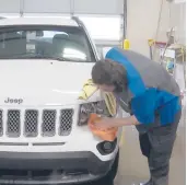  ?? MIKE HOUSEHOLDE­R/AP ?? In this image made from video, a worker washes a Jeep last month inside the service department of a LaFontaine auto dealership in Fenton Township, Mich.