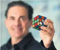  ?? STEVE RUSSELL TORONTO STAR FILE PHOTO ?? Spin Master Toys co-founder/co-ceo Anton Rabie holds up a Rubik’s Cube. Spin Master has acquired 22 toy brands since its launch in 1994, with 12 of those scooped up since 2015.